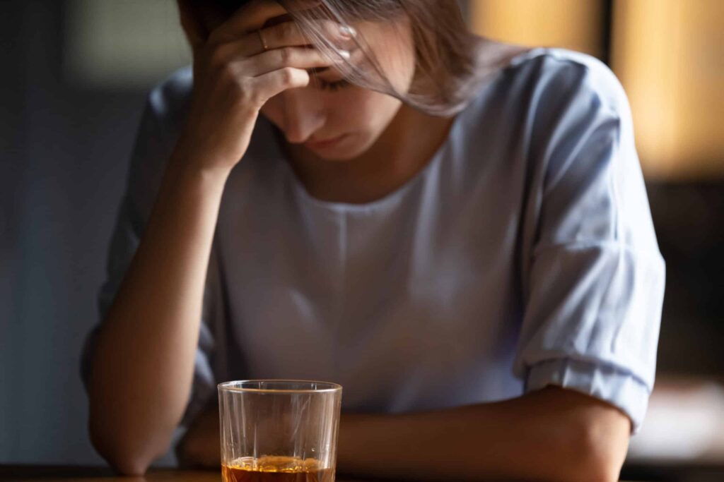 A woman with risk factors for alcoholism.