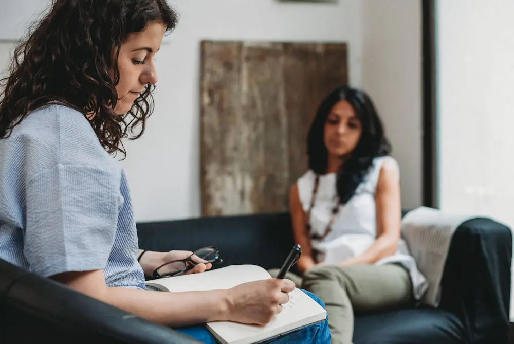 Therapist noting symptoms during a dual diagnosis session in Birmingham, AL